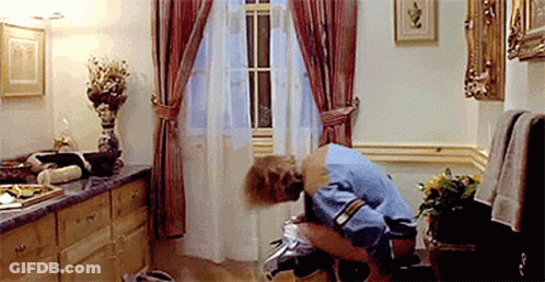 A Woman Is Squatting Down In A Bathroom With A Window . GIF