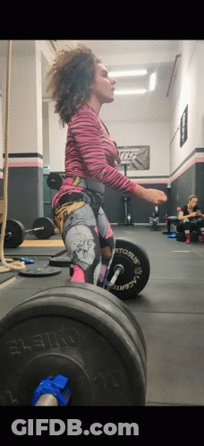 A Woman Is Squatting With A Barbell That Says Leiko GIF