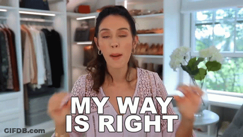 A Woman Is Standing In A Closet Holding A Flower And Saying My Way Is Right . GIF