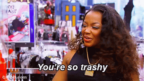A Woman Is Standing In A Clothing Store And Talking To Someone . GIF