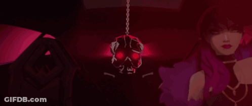 A Woman Is Standing In A Dark Room With A Skull Hanging From The Ceiling GIF