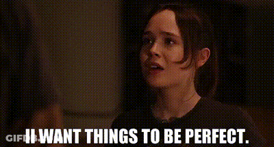 A Woman Is Standing In A Dark Room With The Words `` I Want Things To Be Perfect '' . GIF