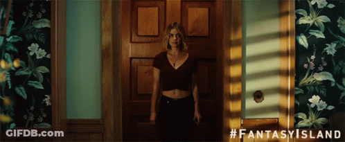 A Woman Is Standing In A Doorway With #Fantasy Island Written On The Bottom GIF