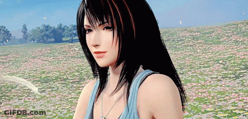 A Woman Is Standing In A Field Of Flowers . GIF
