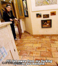 A Woman Is Standing In A Hallway With The Words " Get Away From My Fucking Burrito You Bastard " On The Floor GIF
