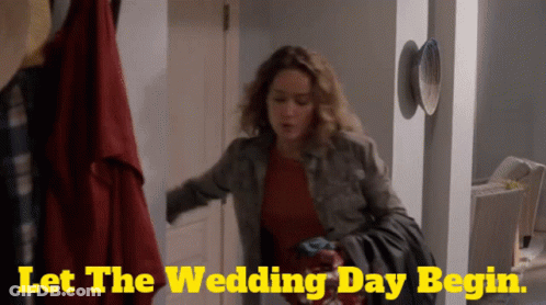 A Woman Is Standing In A Hallway With The Words Let The Wedding Day Begin On The Bottom GIF