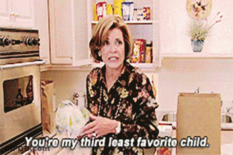 A Woman Is Standing In A Kitchen Holding A Bag Of Food And Talking To Someone . GIF