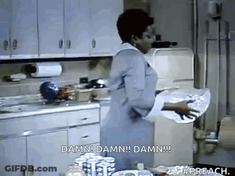 A Woman Is Standing In A Kitchen Holding A Piece Of Paper That Says Damn Damn Damn Damn . GIF
