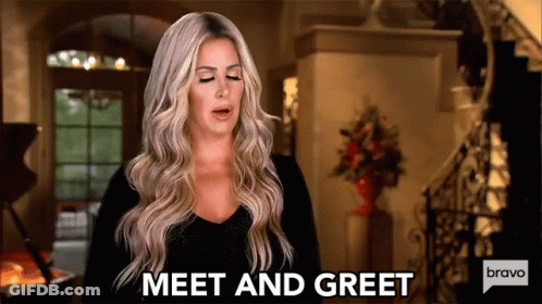 A Woman Is Standing In A Living Room And Says Meet And Greet Bravo . GIF