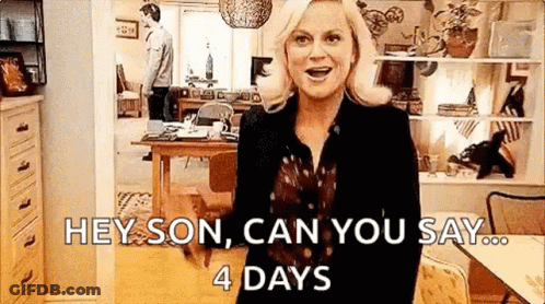 A Woman Is Standing In A Living Room With A Cat And A Man Standing Behind Her . GIF