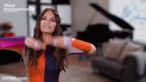 A Woman Is Standing In A Living Room With The Words Real Housewives Out Of Context On The Bottom GIF