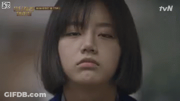 A Woman Is Standing In A Phone Booth With A Sign That Says G. GIF