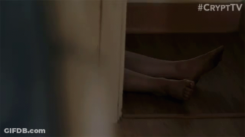 A Woman Is Standing In A Room With A Blurred Background . GIF