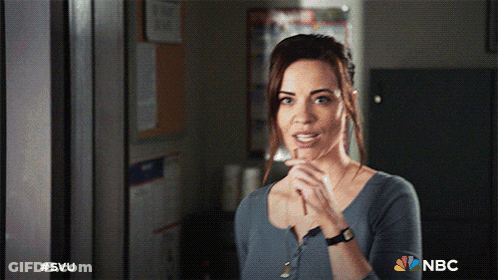 A Woman Is Standing In A Room With The Nbc Logo On The Bottom GIF