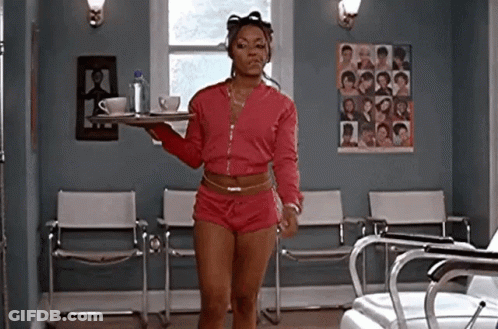 A Woman Is Standing In A Waiting Room Holding A Tray Of Coffee And Tea . GIF