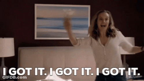 A Woman Is Standing In Front Of A Bed With Her Arms Outstretched And A Picture On The Wall . GIF