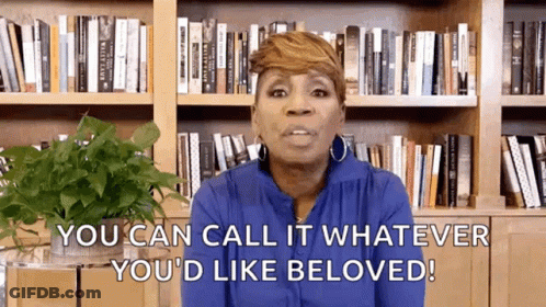 A Woman Is Standing In Front Of A Bookshelf And Saying `` You Can Call It Whatever You 'D Like Beloved ! '' GIF