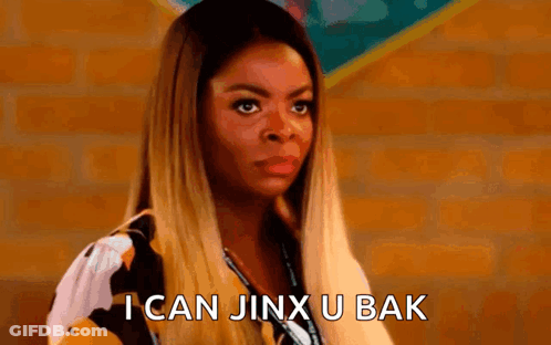 A Woman Is Standing In Front Of A Brick Wall And Says `` I Can Jinx U Bak '' . GIF