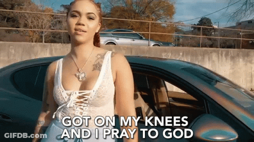 A Woman Is Standing In Front Of A Car With The Words `` Got On My Knees And I Pray To God '' GIF