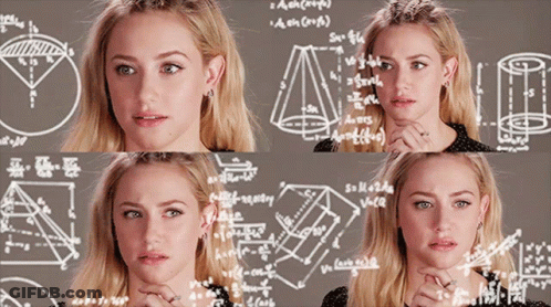 A Woman Is Standing In Front Of A Chalkboard With Mathematical Equations On It GIF