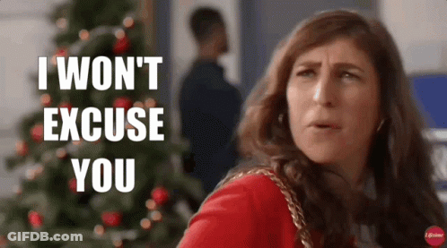 A Woman Is Standing In Front Of A Christmas Tree And Saying I Won 'T Excuse You GIF