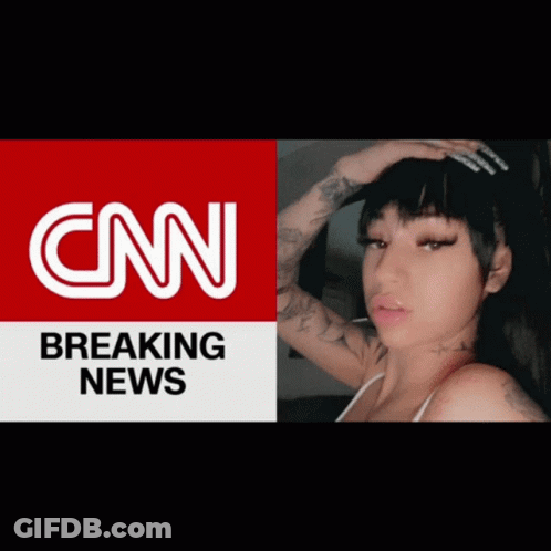 A Woman Is Standing In Front Of A Cnn Breaking News Advertisement GIF