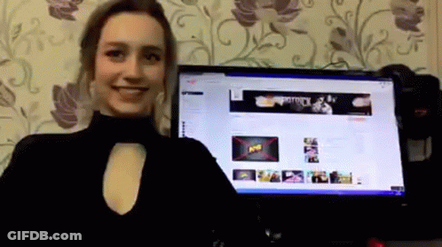 A Woman Is Standing In Front Of A Computer Monitor With A Banner On The Screen That Says " Army " GIF