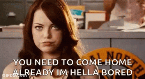 A Woman Is Standing In Front Of A Counter And Talking To Someone . GIF