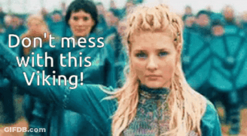 A Woman Is Standing In Front Of A Crowd With The Words " Do N't Mess With This Viking " On The Bottom GIF
