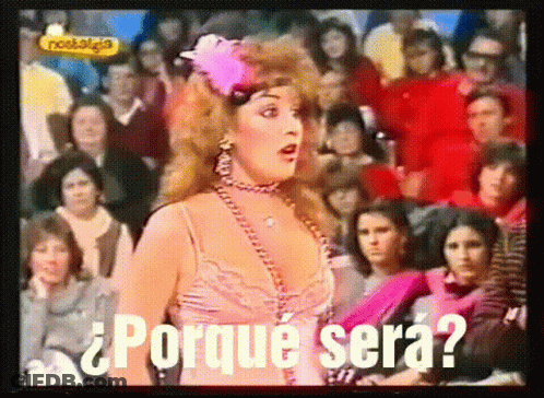 A Woman Is Standing In Front Of A Crowd With The Words Porque Sera Written On The Screen GIF