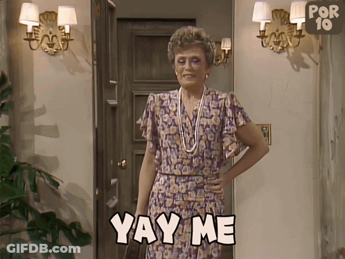 A Woman Is Standing In Front Of A Door And Says Yay Me GIF