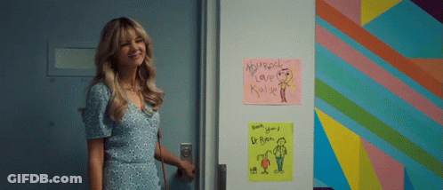 A Woman Is Standing In Front Of A Door That Has A Sign On It That Says Microsoft Love Kyle GIF