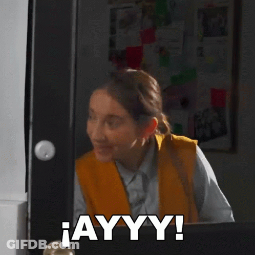 A Woman Is Standing In Front Of A Door With The Word Ayyy Written On It GIF