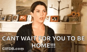 A Woman Is Standing In Front Of A Fireplace In A Living Room And Says `` Cant Wait For You To Be Home ! '' GIF