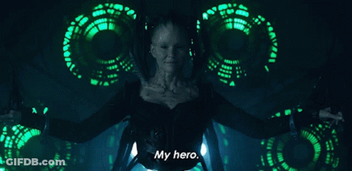 A Woman Is Standing In Front Of A Green Background And Says My Hero GIF