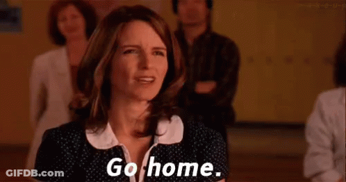 A Woman Is Standing In Front Of A Group Of People And Saying `` Go Home . '' GIF