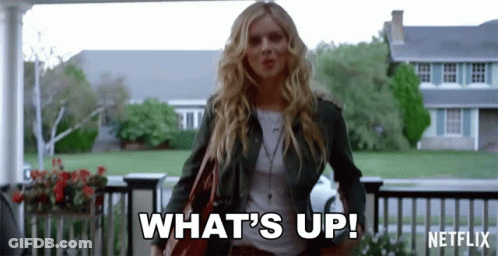 A Woman Is Standing In Front Of A House And Saying What 'S Up GIF