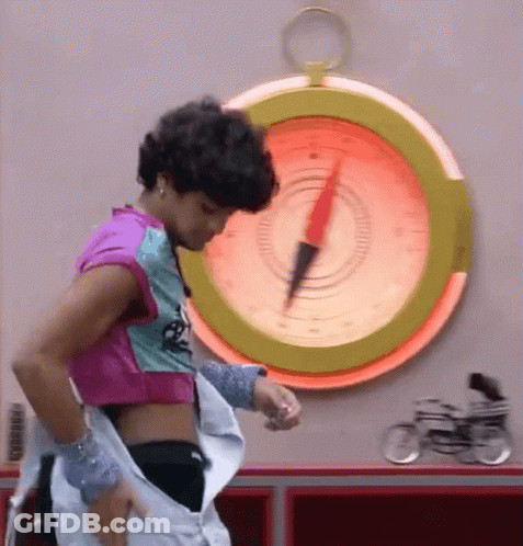 Woman Standing In Front Of Large Compass Pointing Right GIF