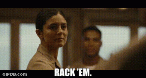 A Woman Is Standing In Front Of A Man And Says Rack 'Em GIF