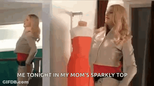 A Woman Is Standing In Front Of A Mannequin Wearing A Red Dress In Front Of A Mirror . GIF