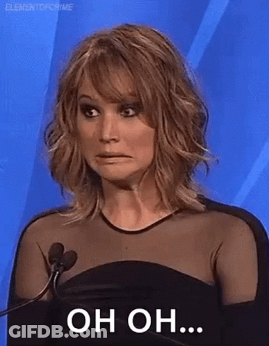 A Woman Is Standing In Front Of A Microphone And Making A Face . GIF