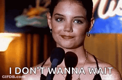 A Woman Is Standing In Front Of A Microphone And Says I Don 'T Wanna Wait . GIF