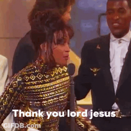 A Woman Is Standing In Front Of A Microphone While A Man In A Suit Talks To Her . GIF