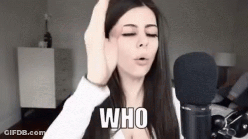 A Woman Is Standing In Front Of A Microphone With Her Eyes Closed And Making A Funny Face . GIF