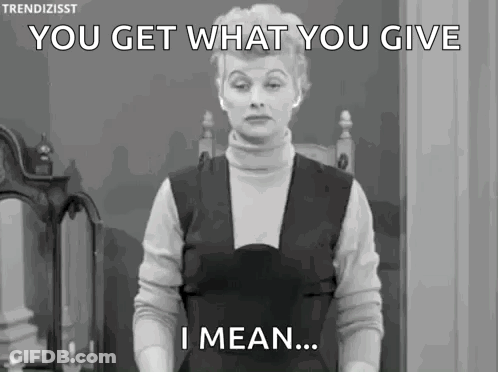 A Woman Is Standing In Front Of A Mirror And Saying `` You Get What You Give I Mean ... '' GIF