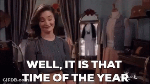 A Woman Is Standing In Front Of A Mirror In A Room . GIF