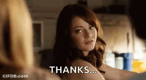 A Woman Is Standing In Front Of A Mirror With The Words `` Thanks '' Written On It . GIF