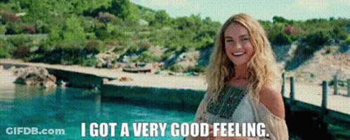 A Woman Is Standing In Front Of A Pool And Smiling . GIF