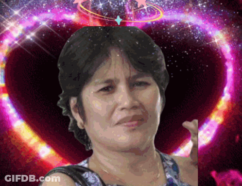 A Woman Is Standing In Front Of A Purple Heart GIF