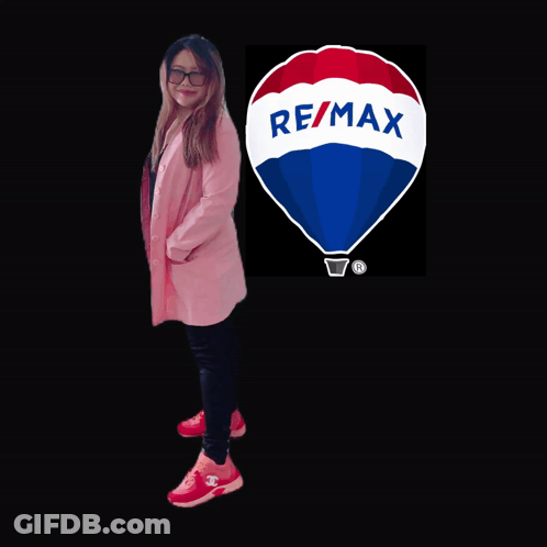 A Woman Is Standing In Front Of A Re/max Logo GIF